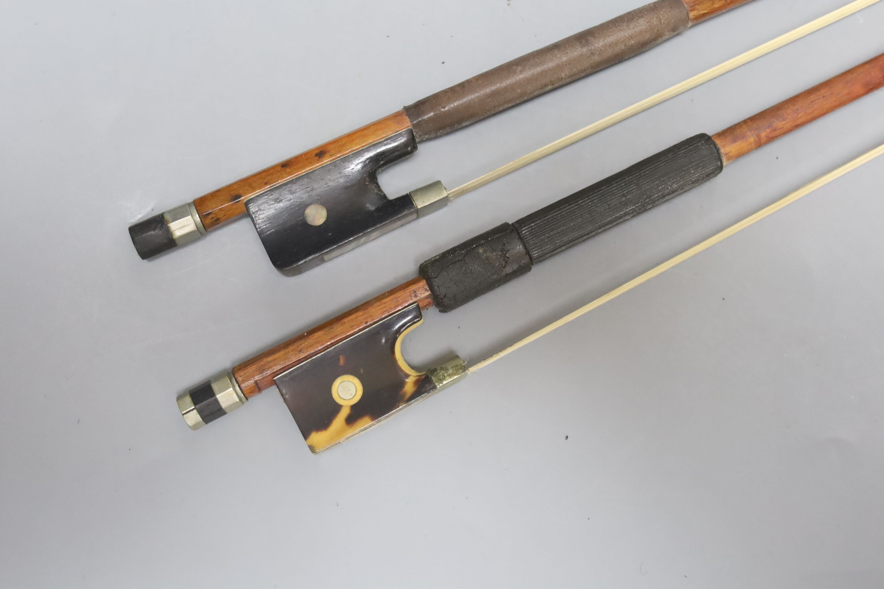 Two cased violin bows, one with tortoiseshell frog, by G.W Wood